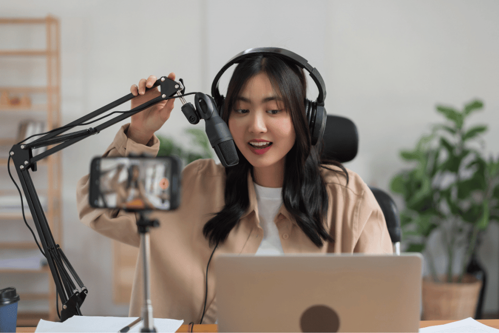 why start a podcast woman in front of camera recording video